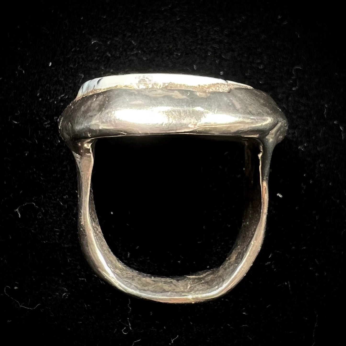A bezel set ring handmade in sterling silver with a white dendritic agate stone.