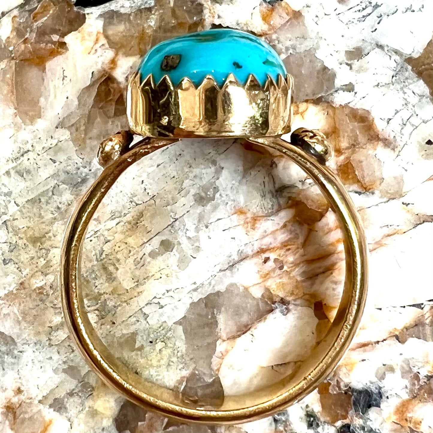 A ladies' yellow gold turquoise ring. The turquoise is a round cabochon cut.