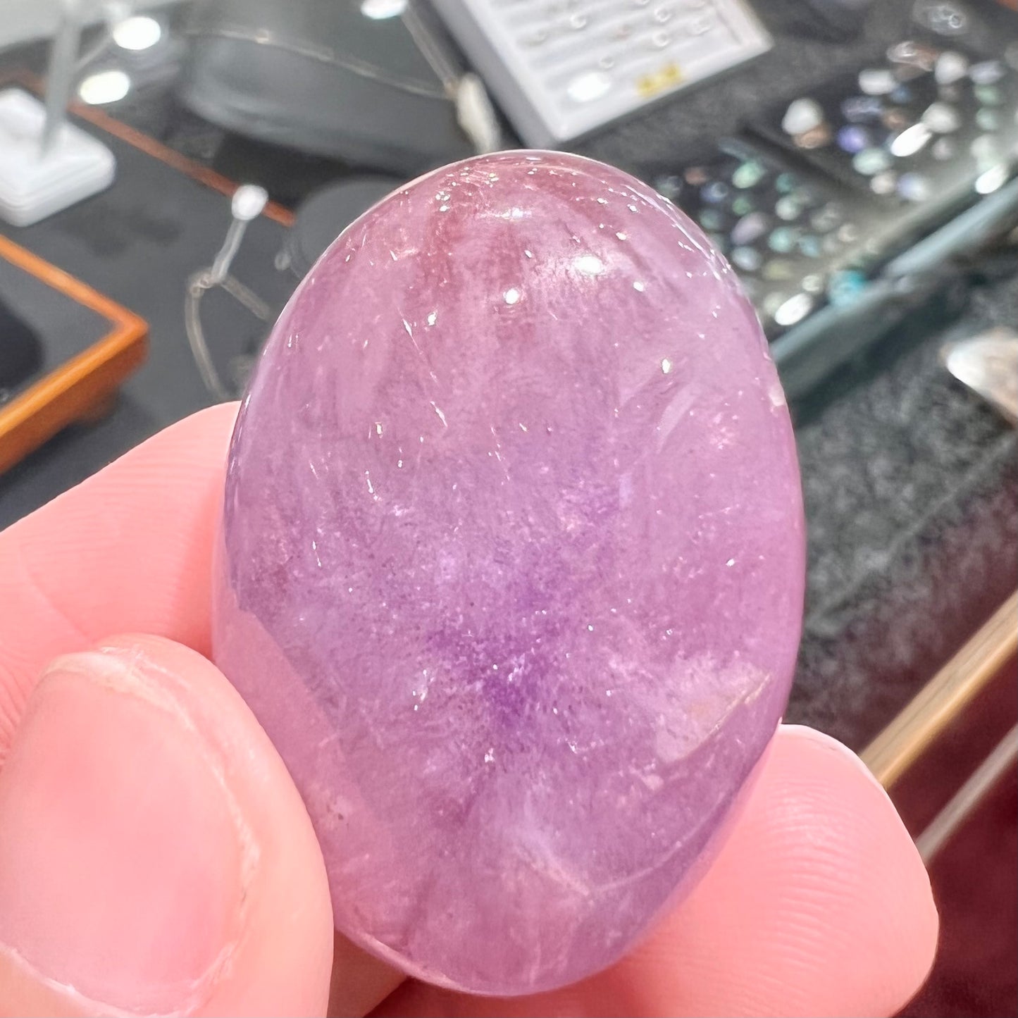 A cabochon cut red amethyst stone from Mexico. The piece shows a faint star.