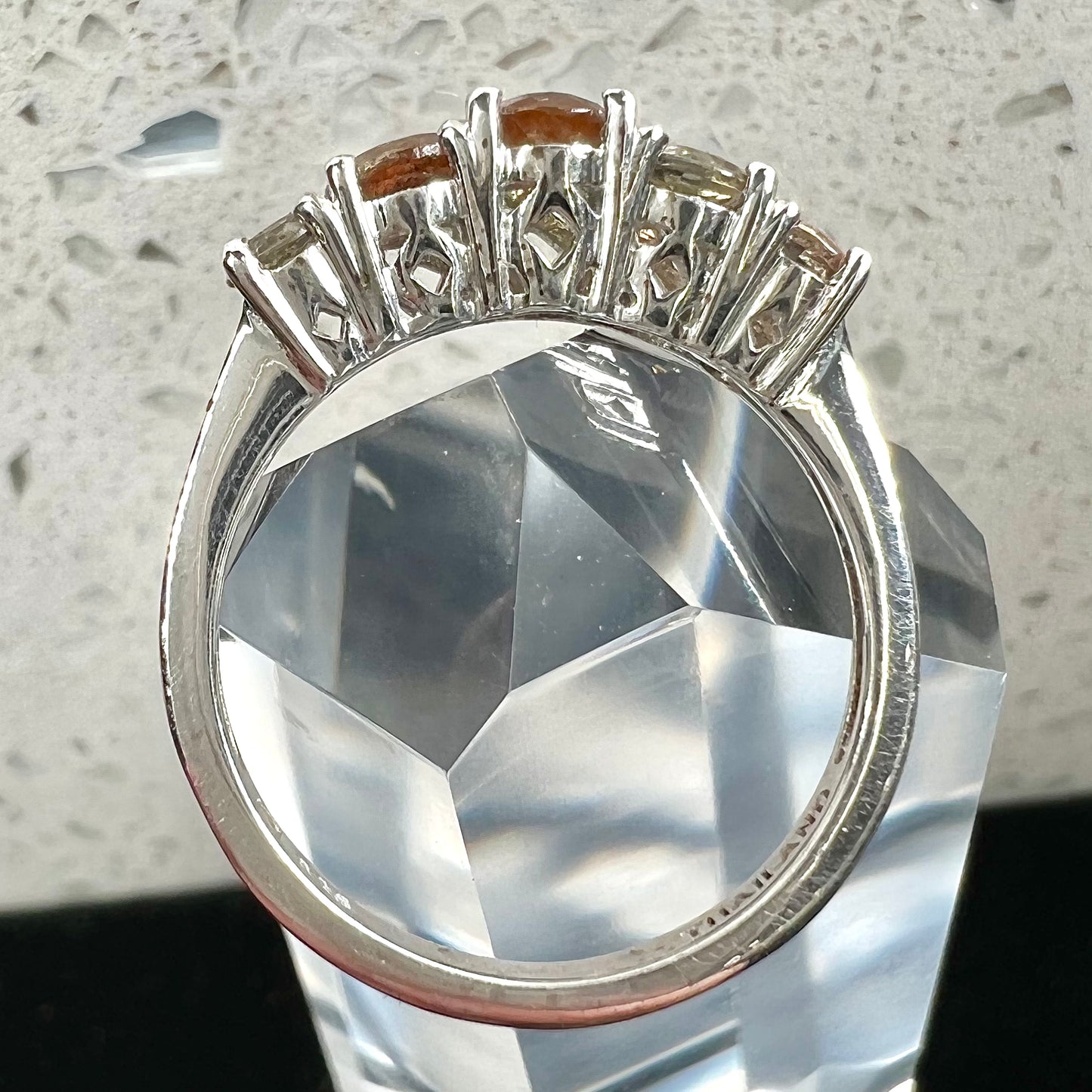 A sterling silver stackable ring set with five faceted oval and round andalusite stones.