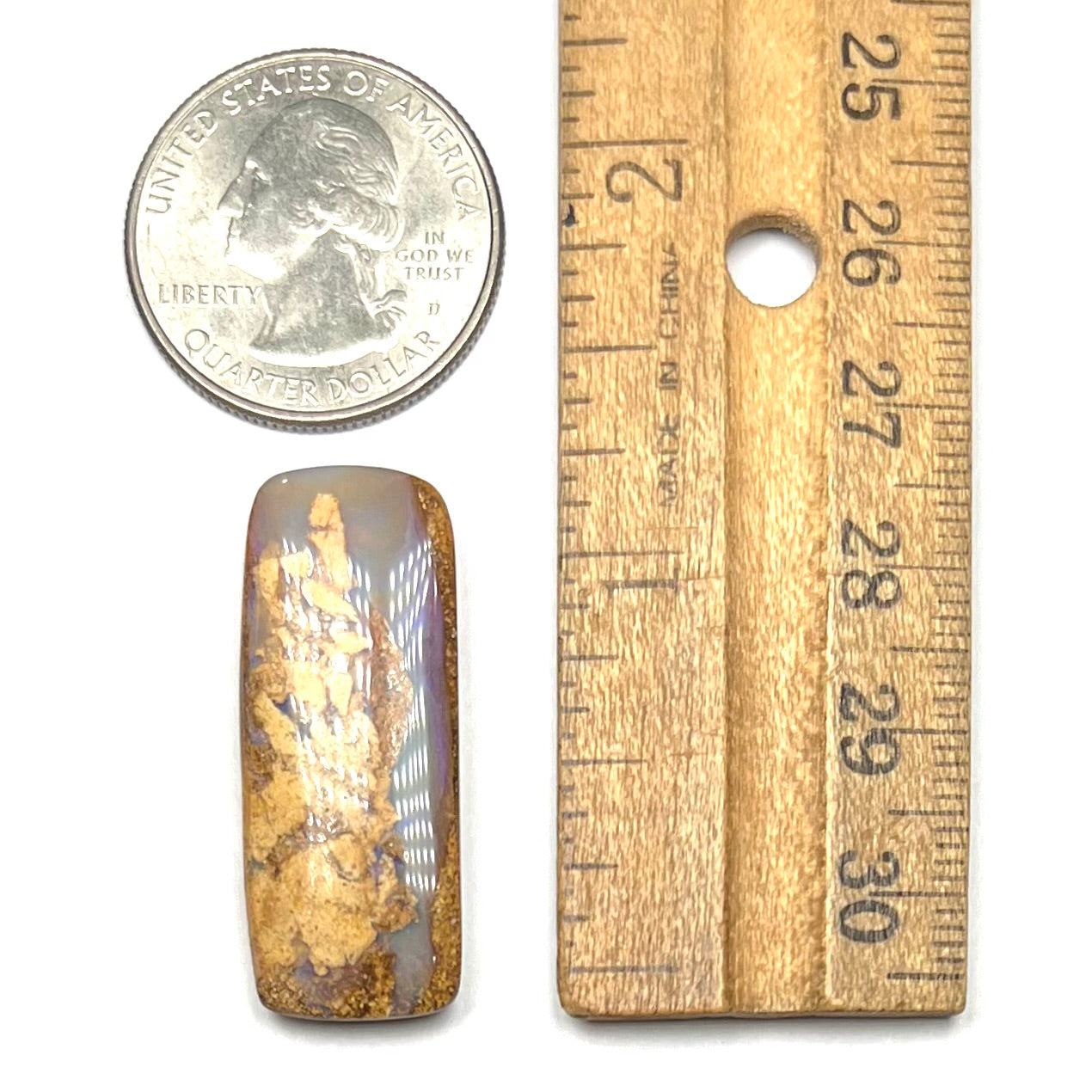 A polished, drilled pipe boulder opal bead.