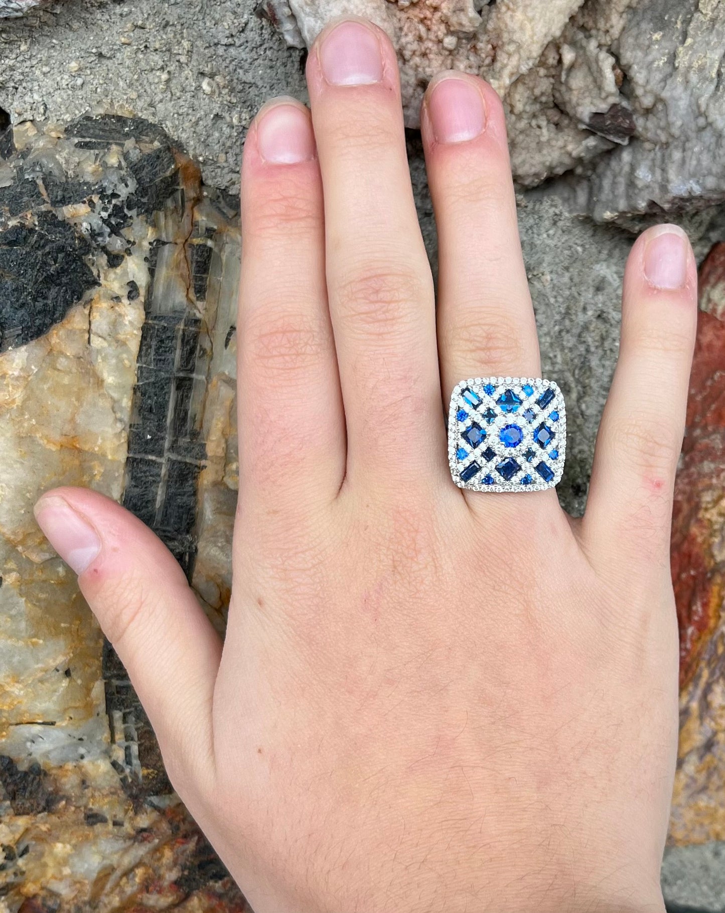 A sterling silver blue and white synthetic stone ring. The ring strongly resembles a blueberry pie.