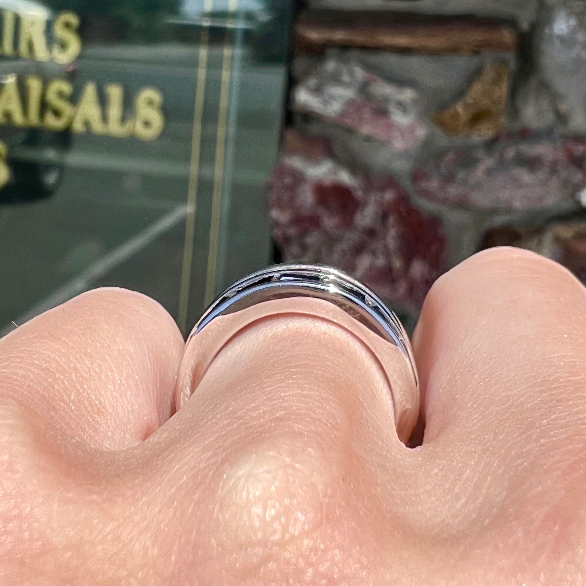 A silver ring set with red, white, and blue baguette cut stones.  The gallery features two stars.