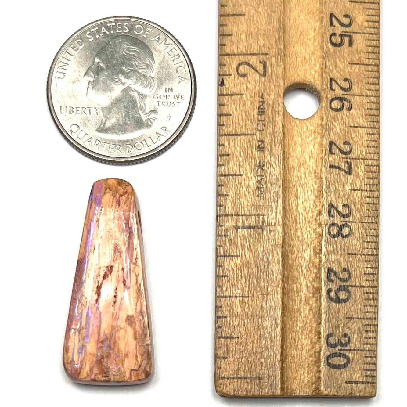 A polished, drilled pipe boulder opal bead.