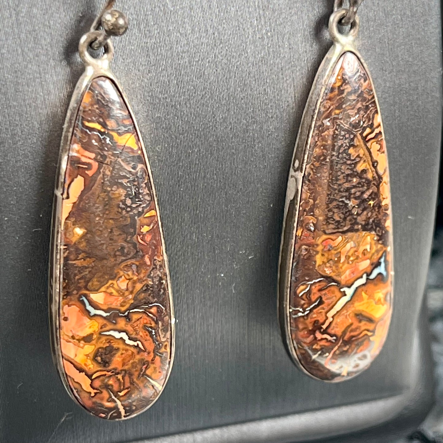 A pair of sterling silver boulder opal drop dangle earrings.