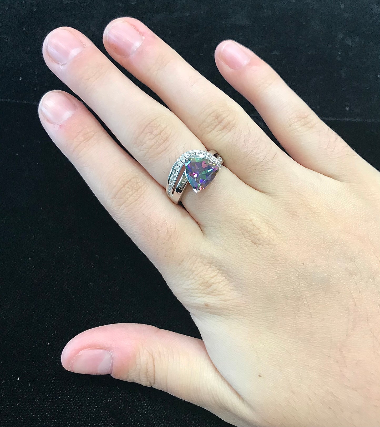 Mystic topaz ring with cubic zirconia side stones set in sterling silver with a double band design.