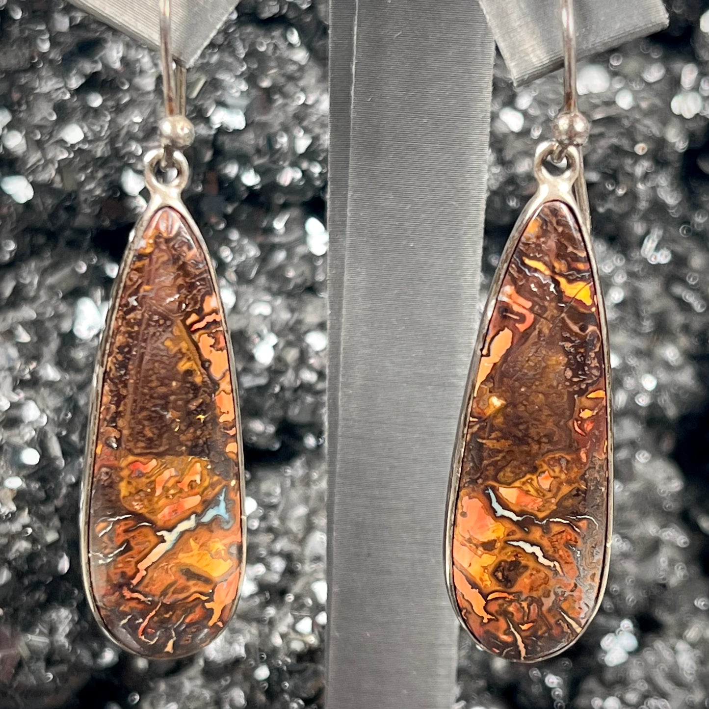 A pair of sterling silver boulder opal drop dangle earrings.