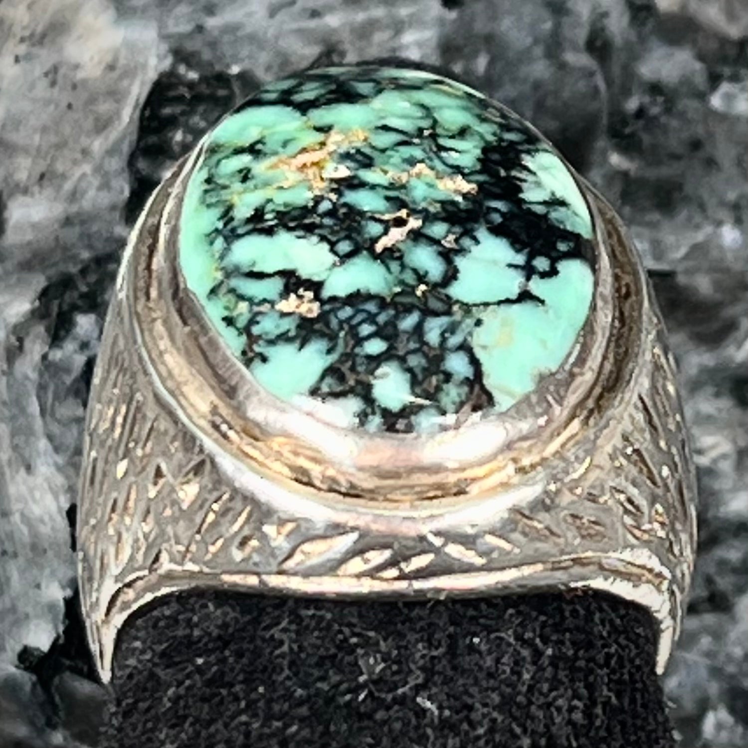 A sterling silver solitaire ring set with a black spiderweb turquoise stone from Kingman, Arizona.