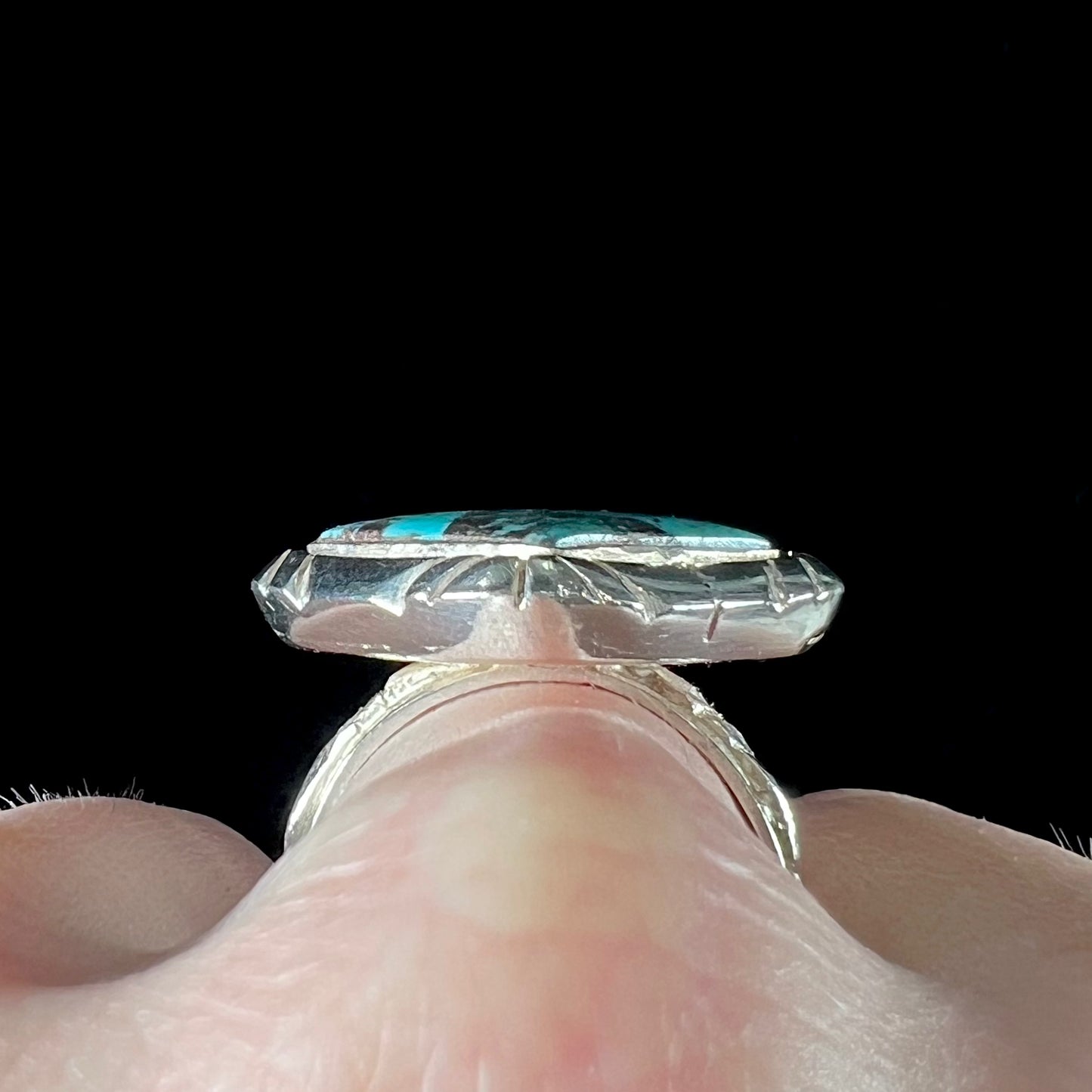 A handmade sterling silver, unisex, likely Navajo ring set with Tibetan turquoise.