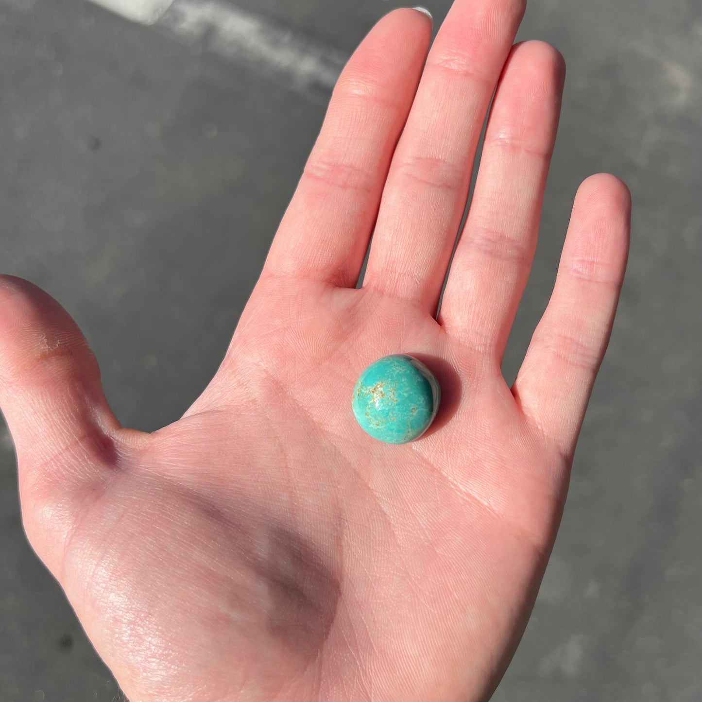 Loose round cabochon cut Royston turquoise stone.