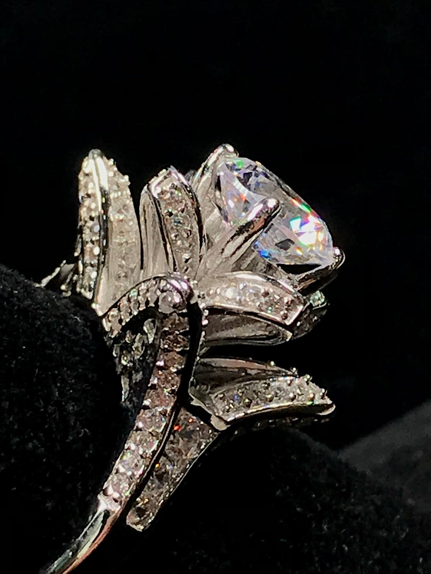A blooming flower motif ring set with round, white cubic zirconia.