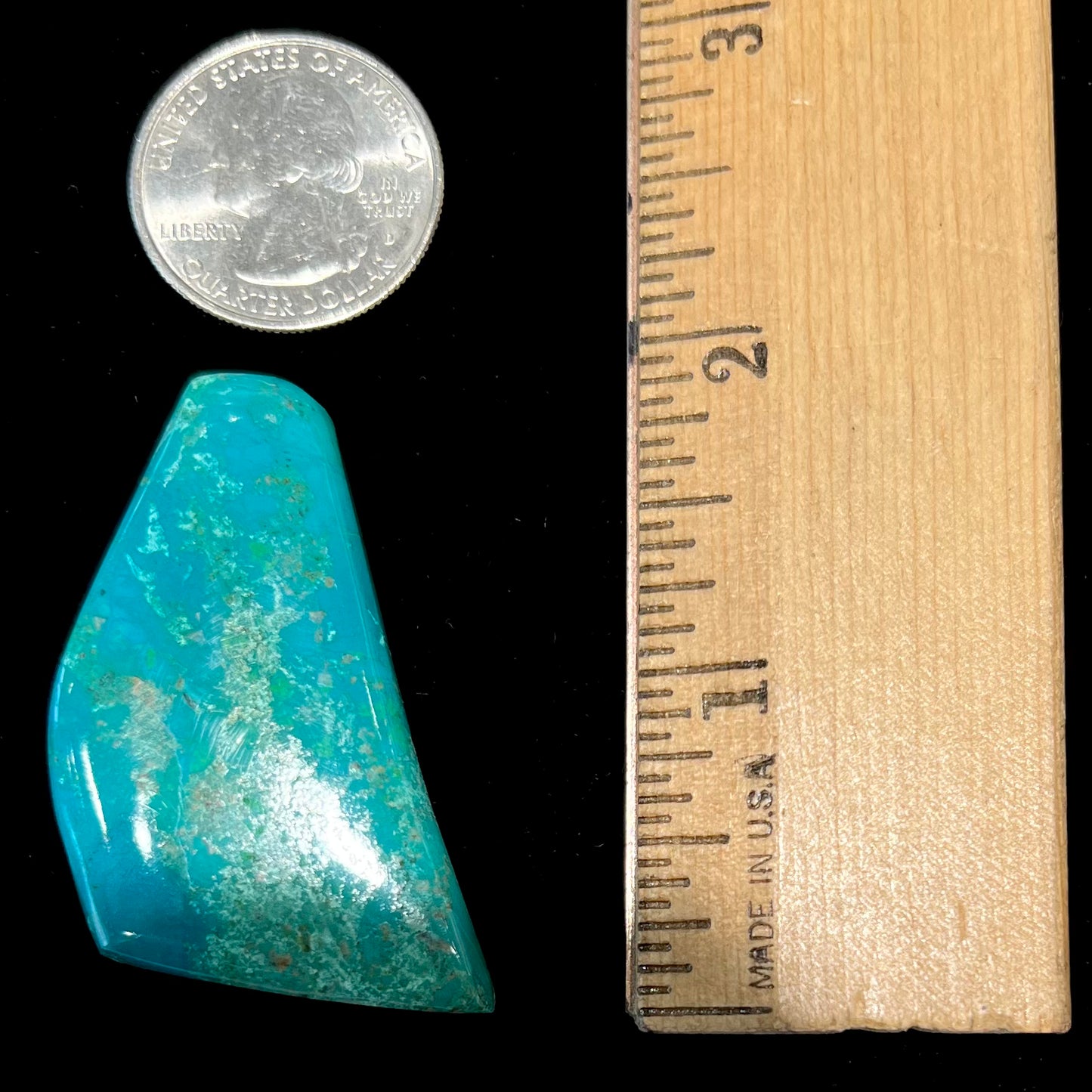 A freeform cut chrysocolla stone cabochon.