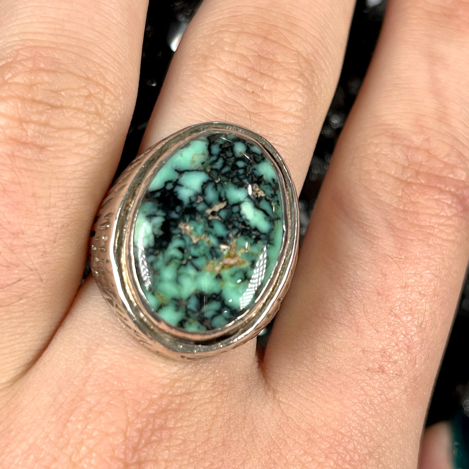 A sterling silver solitaire ring set with a black spiderweb turquoise stone from Kingman, Arizona.