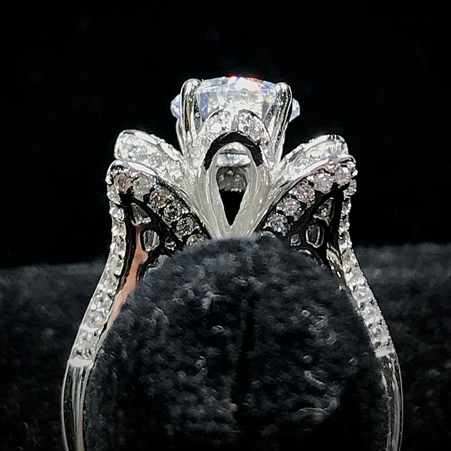 A blooming flower motif ring set with round, white cubic zirconia.