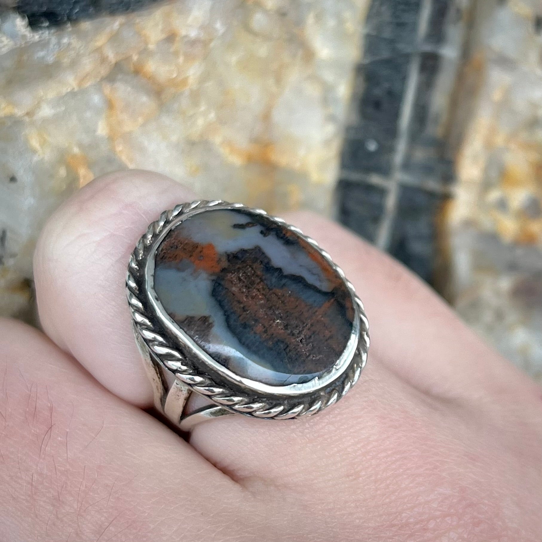 Plume Agate ring set in sterling silver with a twisted rope bezel design.