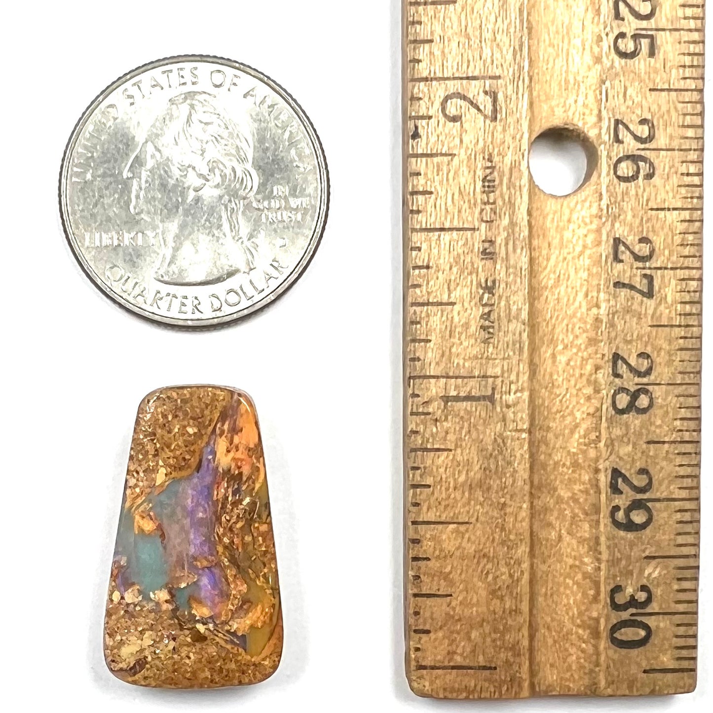 A polished, drilled pipe boulder opal bead.