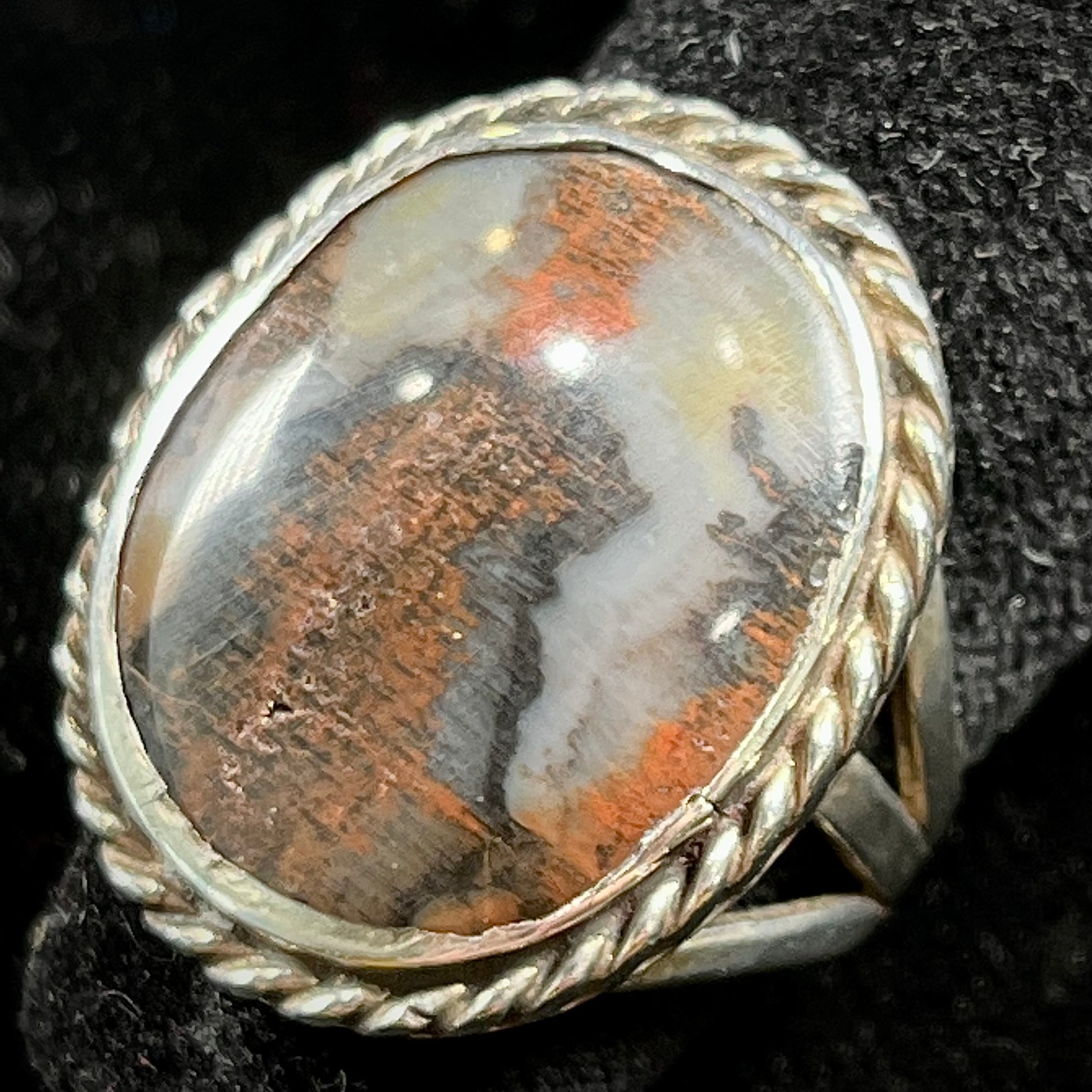 Plume Agate ring set in sterling silver with a twisted rope bezel design.