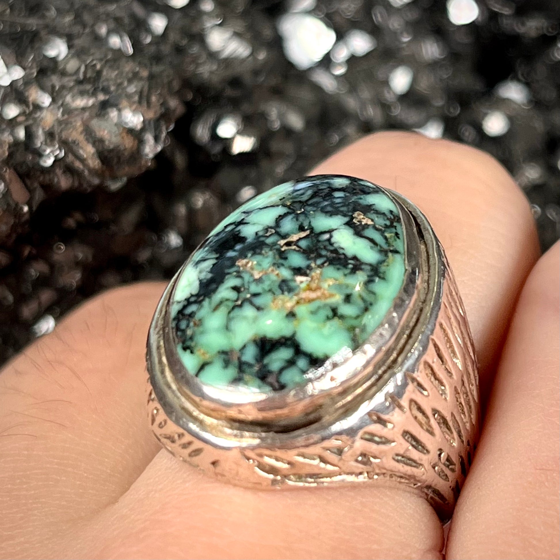 A sterling silver solitaire ring set with a black spiderweb turquoise stone from Kingman, Arizona.