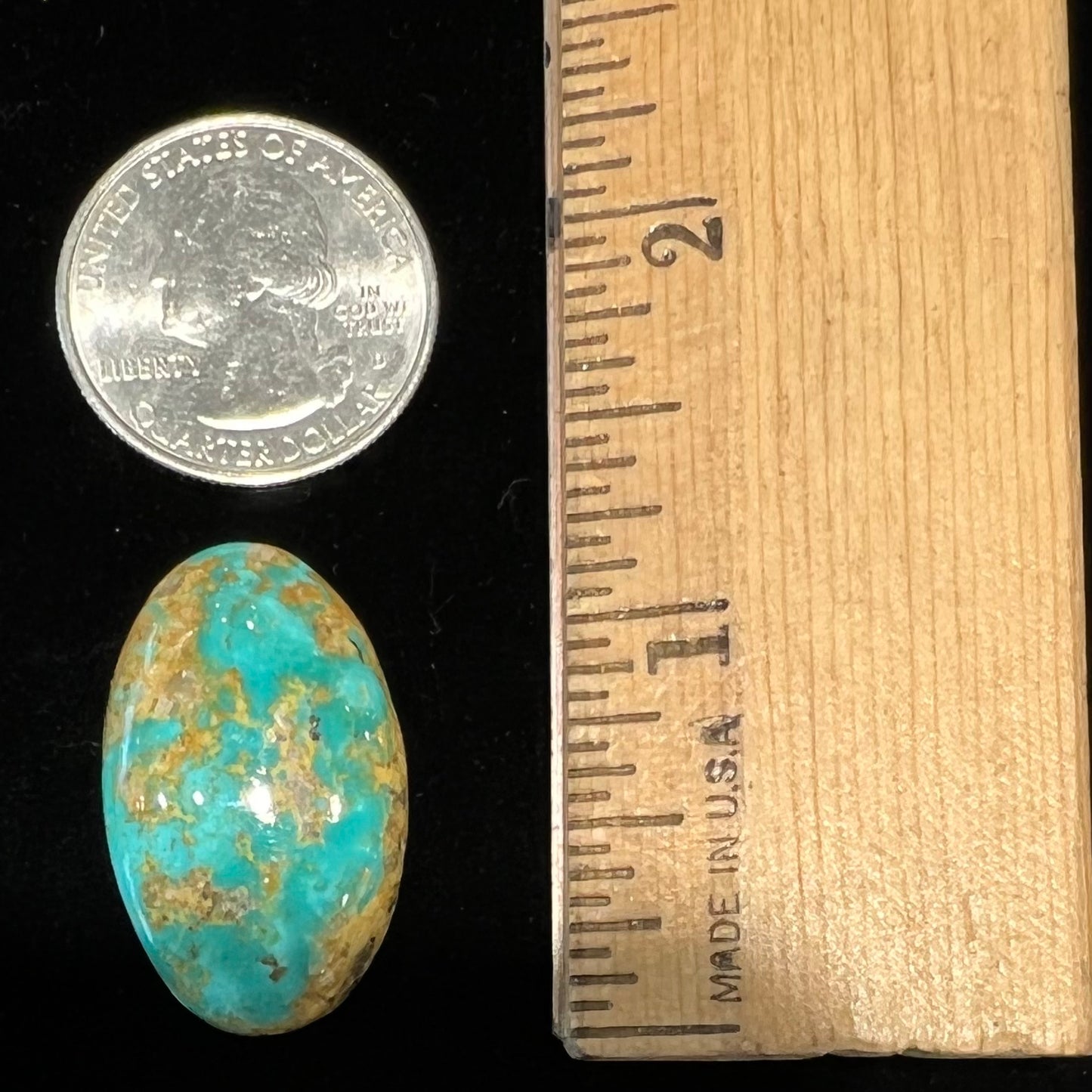 An oval cabochon cut turquoise stone from Manassa, Colorado.