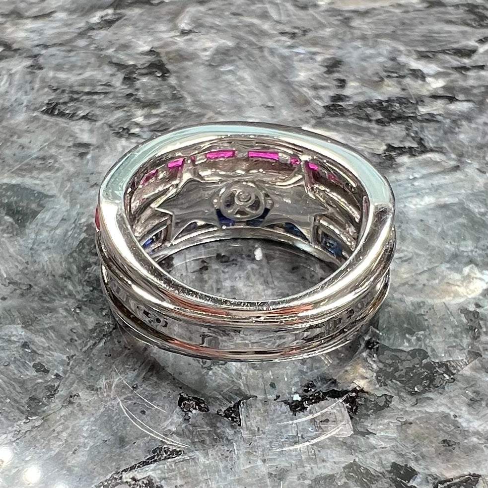 A silver ring set with red, white, and blue baguette cut stones. The gallery features two stars.