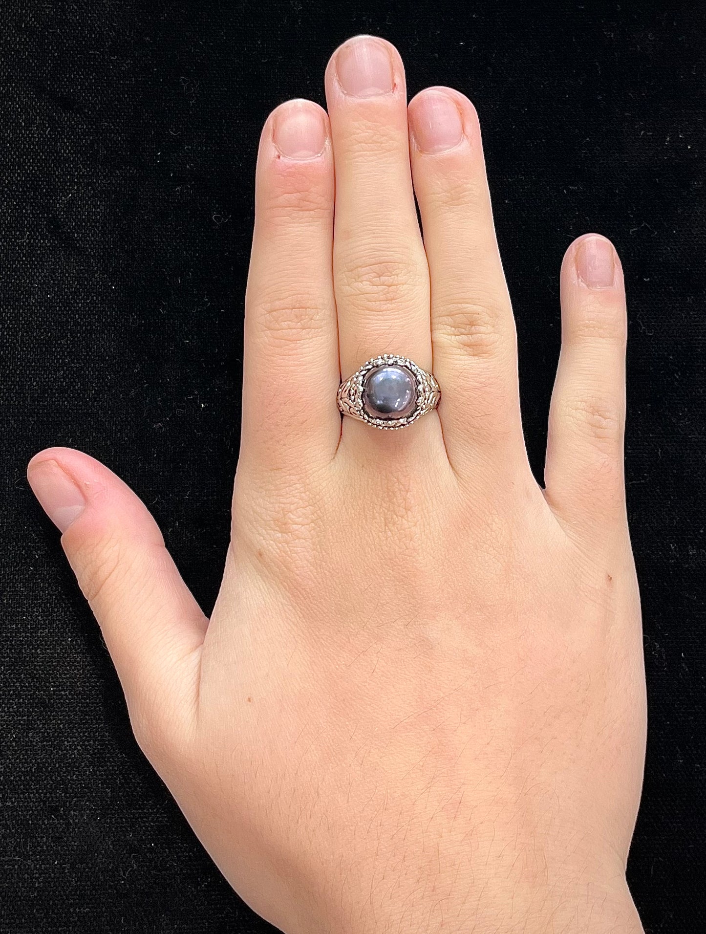 A vintage style sterling silver black pearl filigree ring.