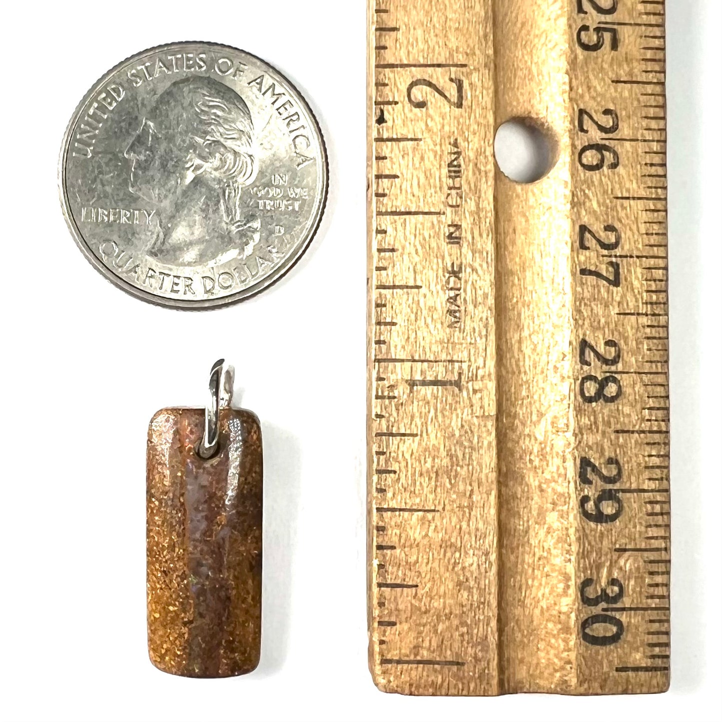 A boulder opal stone pendant with a sterling silver ring from Queensland, Australia.