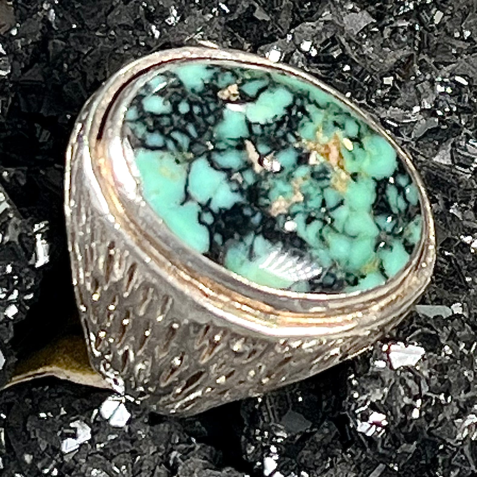 A sterling silver solitaire ring set with a black spiderweb turquoise stone from Kingman, Arizona.