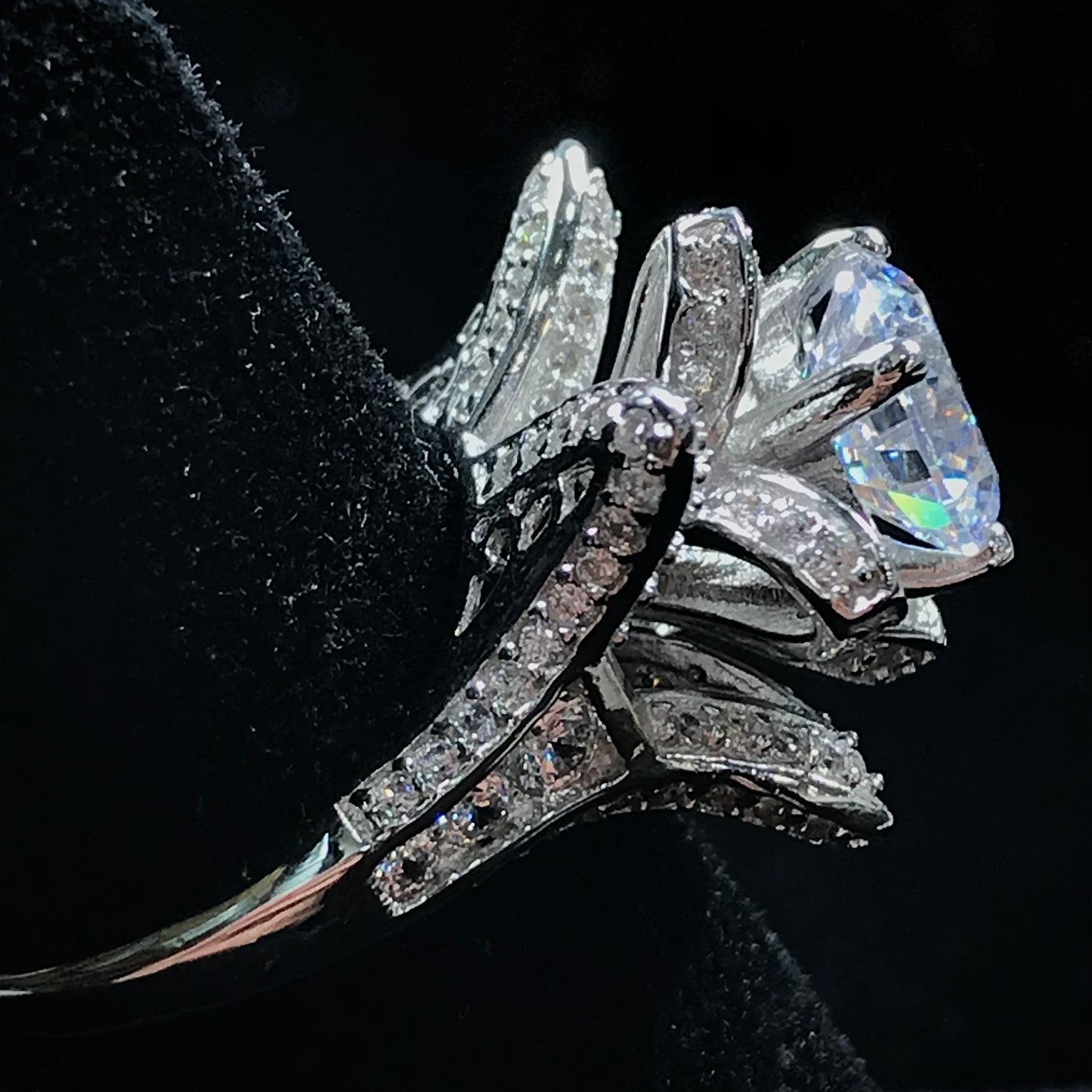 A blooming flower motif ring set with round, white cubic zirconia.