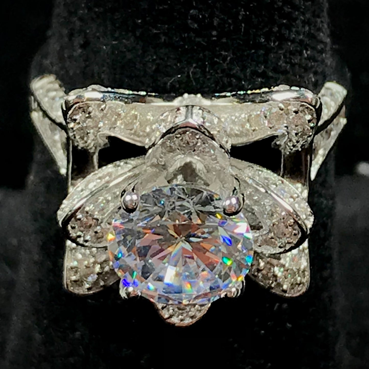 A blooming flower motif ring set with round, white cubic zirconia.