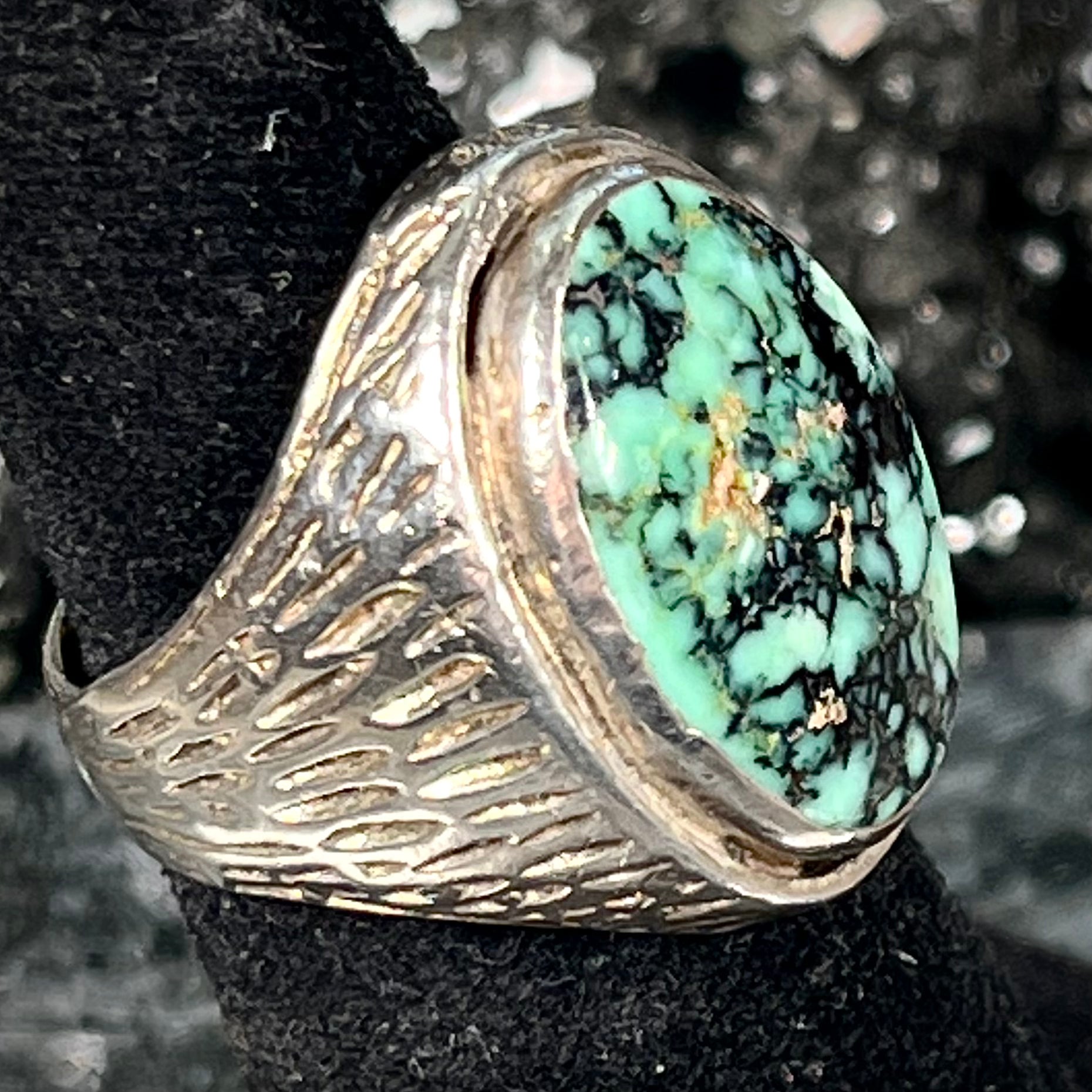 A sterling silver solitaire ring set with a black spiderweb turquoise stone from Kingman, Arizona.