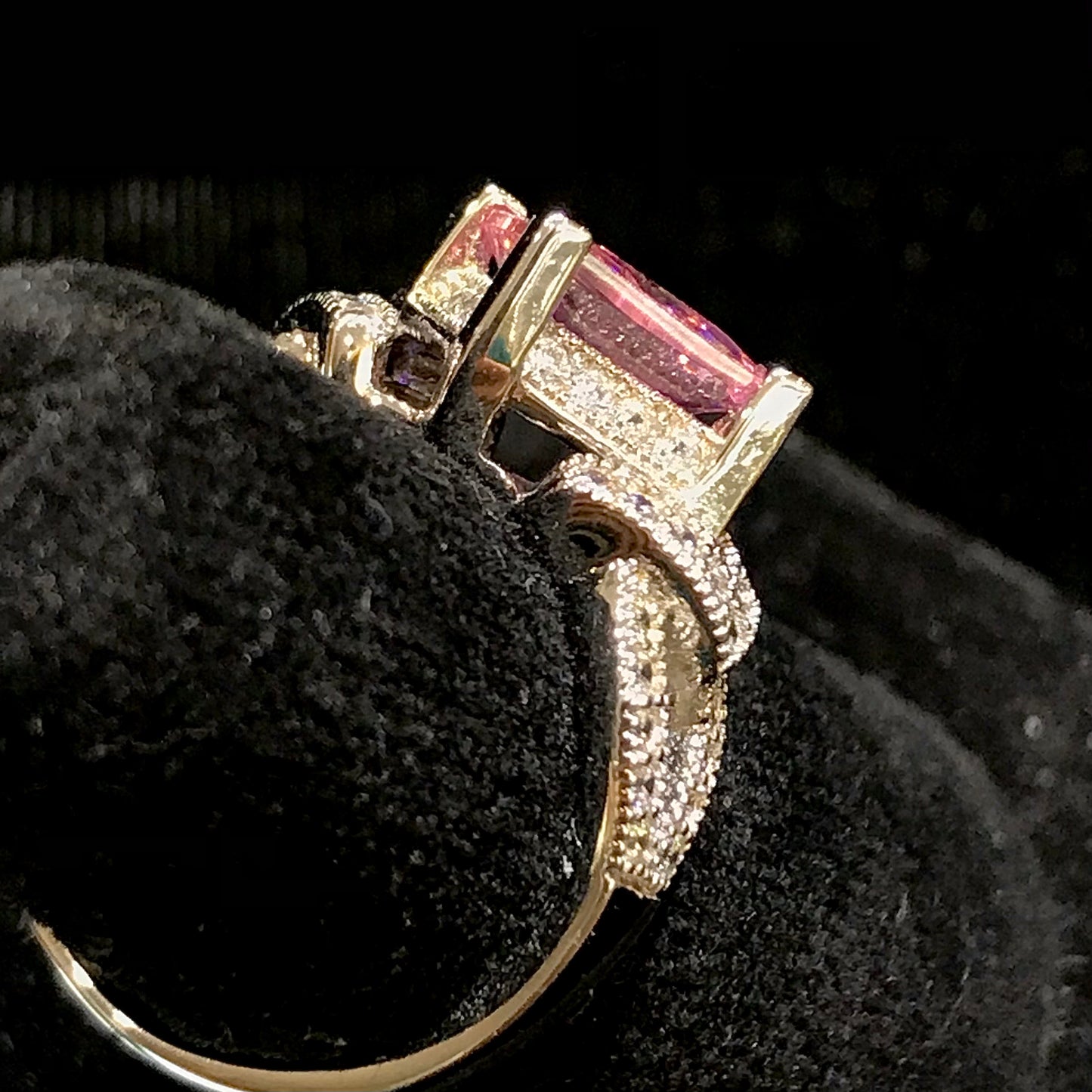 Pink cubic zirconia ring set in sterling silver with white cubic zirconia melee.