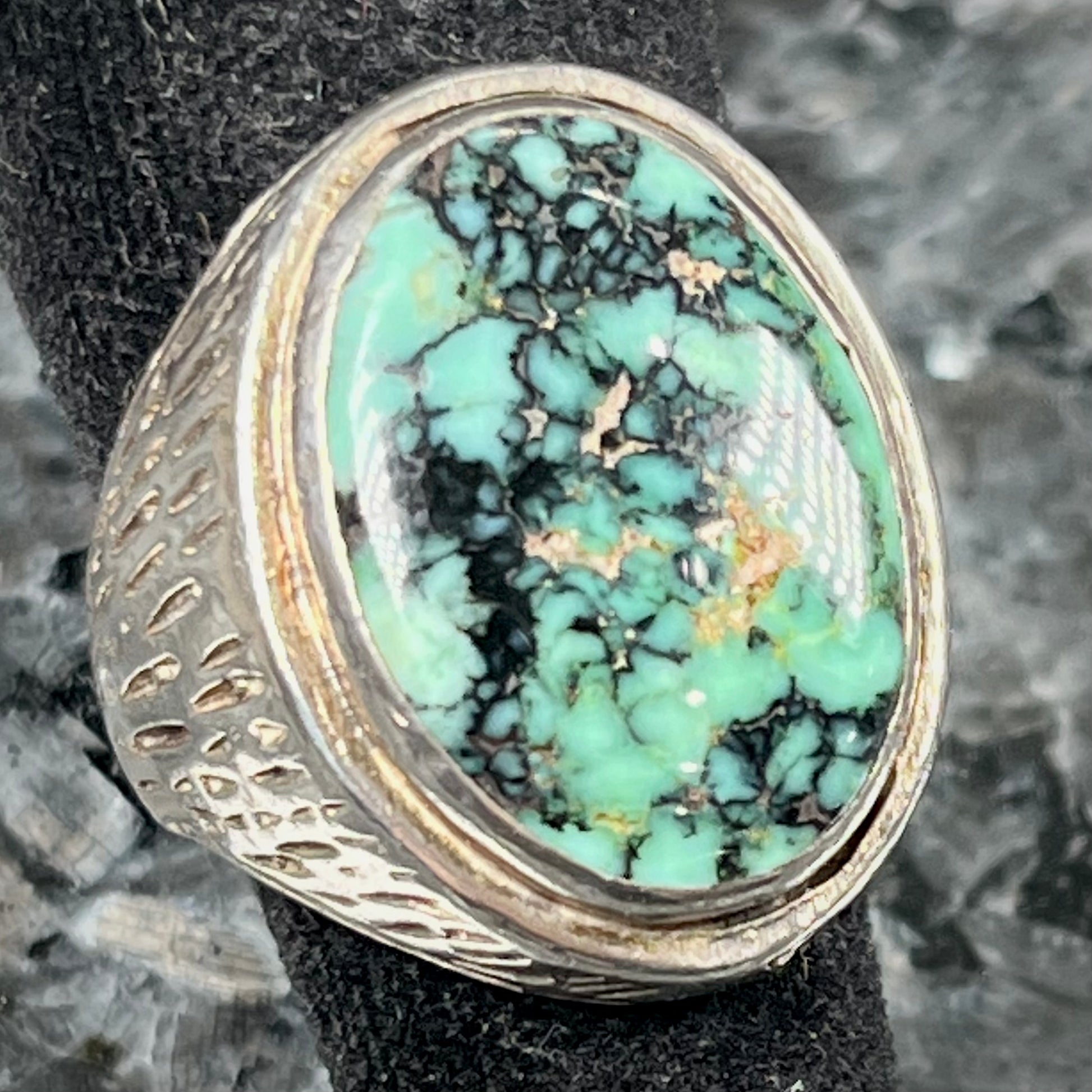 A sterling silver solitaire ring set with a black spiderweb turquoise stone from Kingman, Arizona.