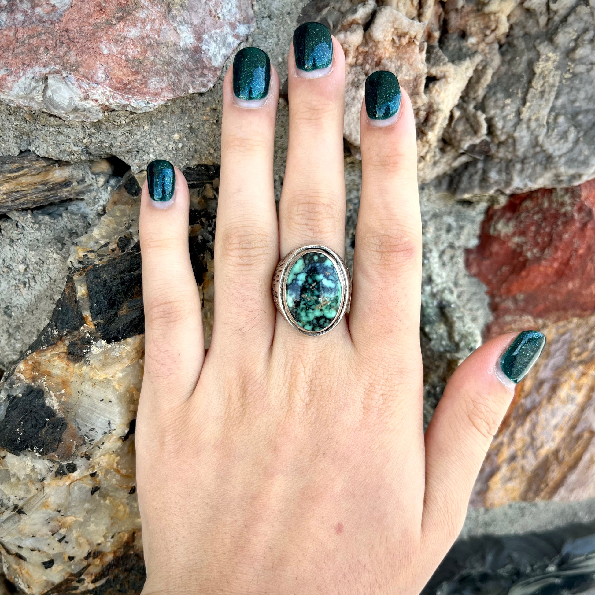 A sterling silver solitaire ring set with a black spiderweb turquoise stone from Kingman, Arizona.