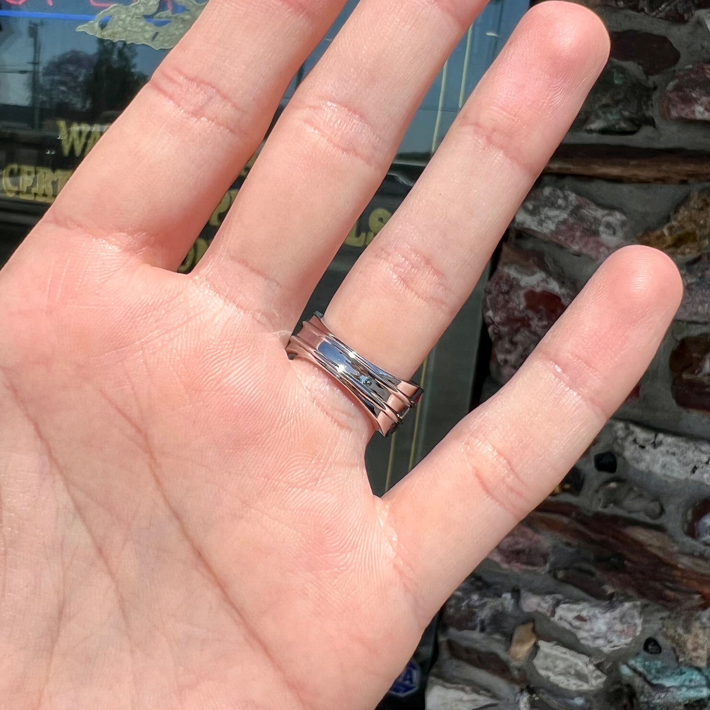 A silver ring set with red, white, and blue baguette cut stones. The gallery features two stars.