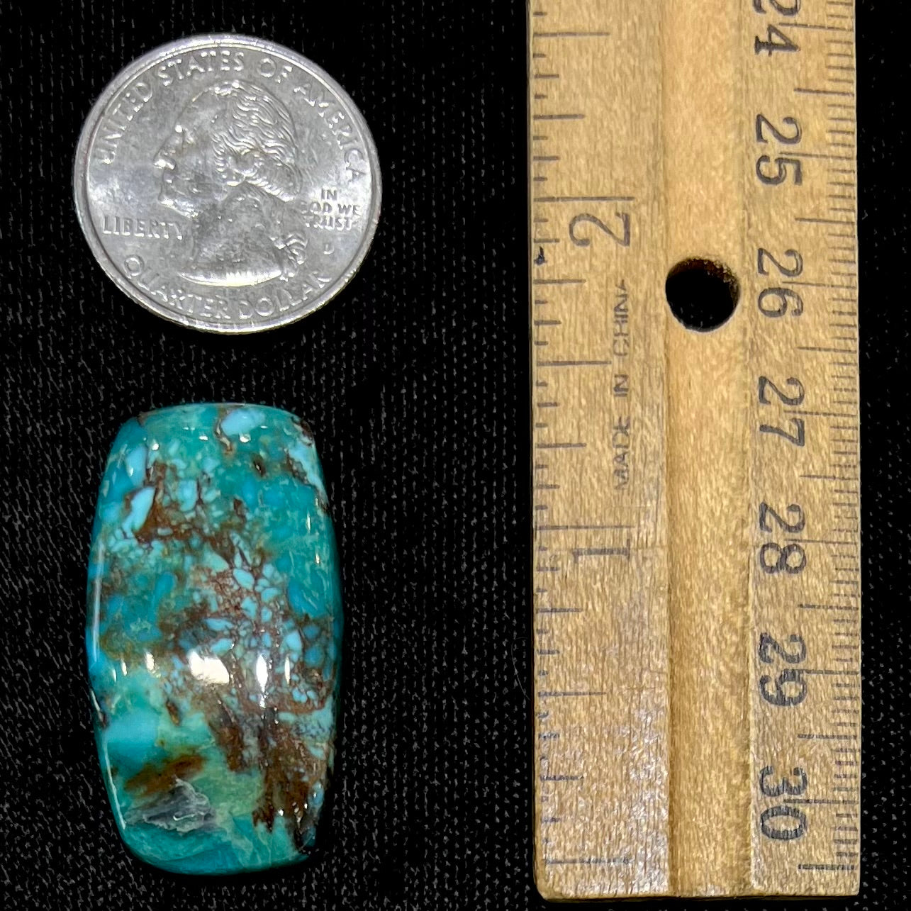 A loose turquoise stone from Royston Mining District, Nevada. The stone is blue green with brown matrix veining.