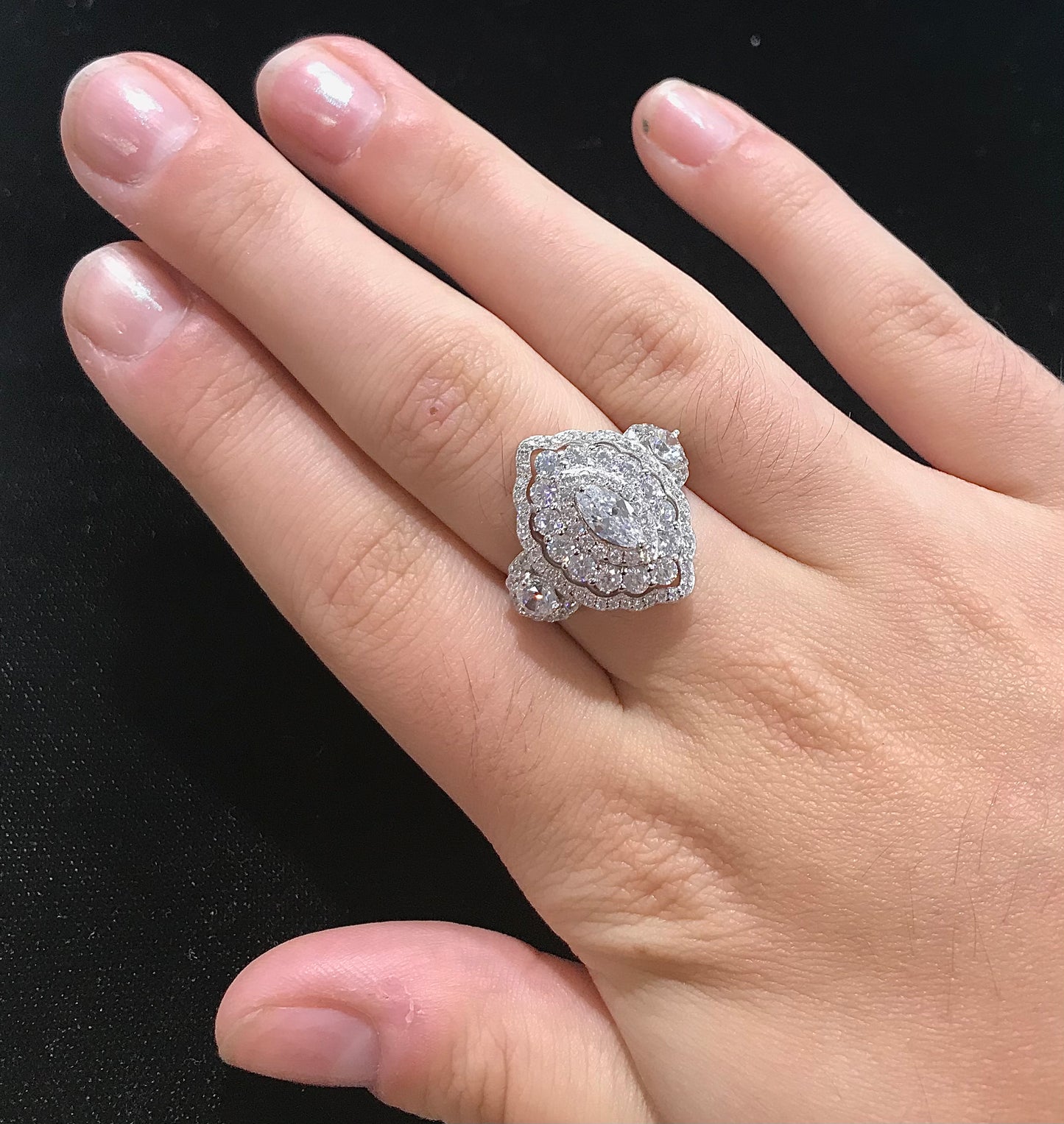 A sterling silver ring set with marquise cut white sapphire stones in sterling silver.