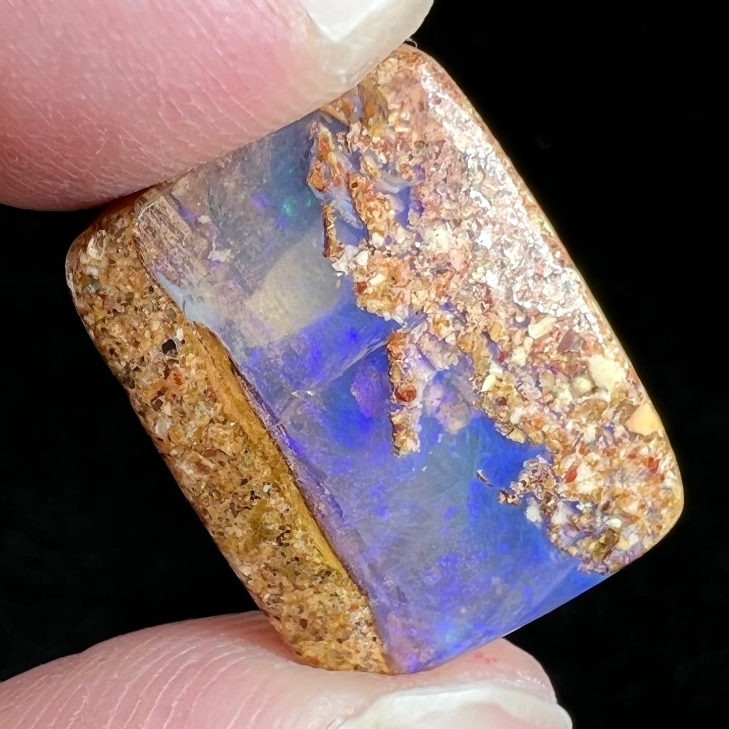 A polished, drilled pipe boulder opal bead.