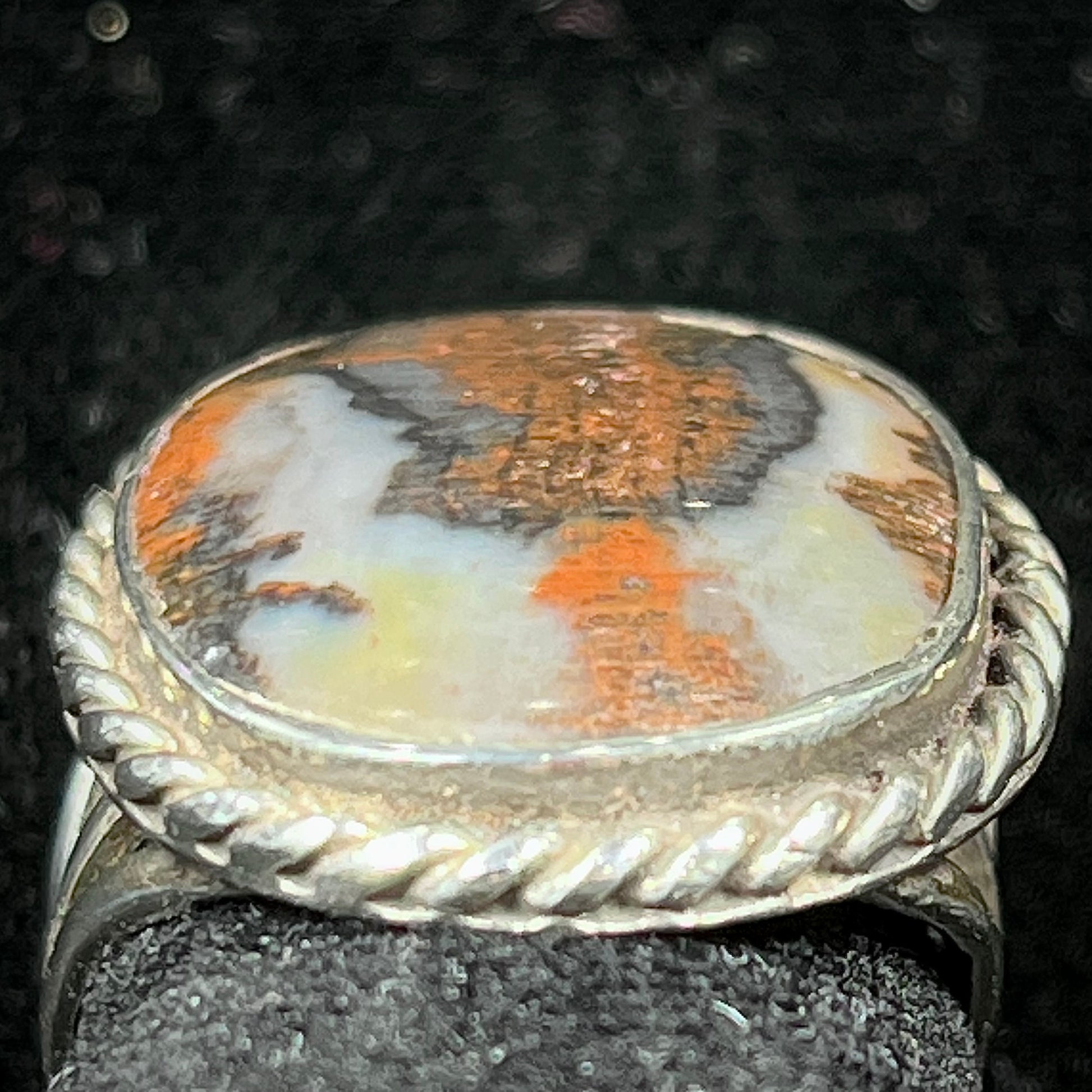 Plume Agate ring set in sterling silver with a twisted rope bezel design.