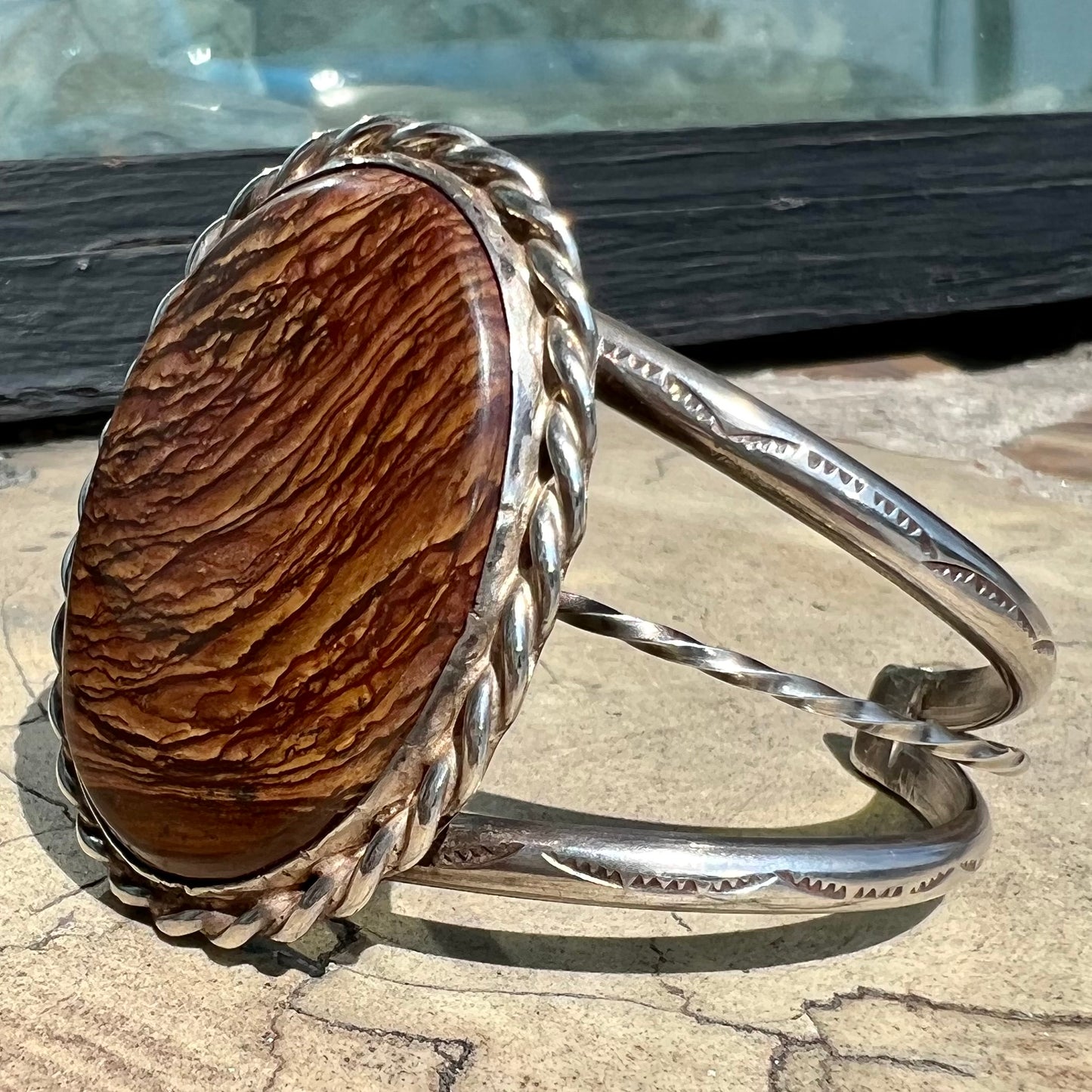 A sterling silver rope bezel set picture jasper cuff bracelet.