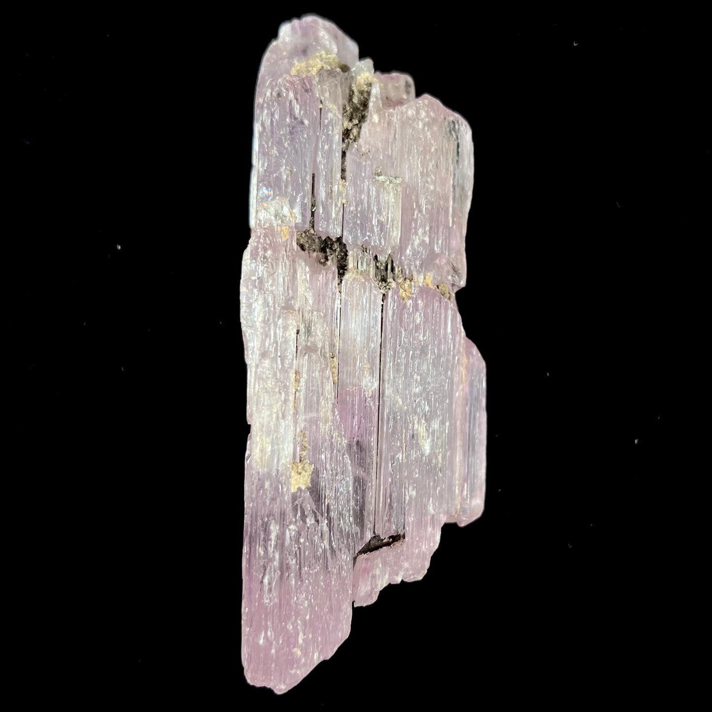 A five inch long pink kunzite crystal. The crystal is purple when viewed down the ends.