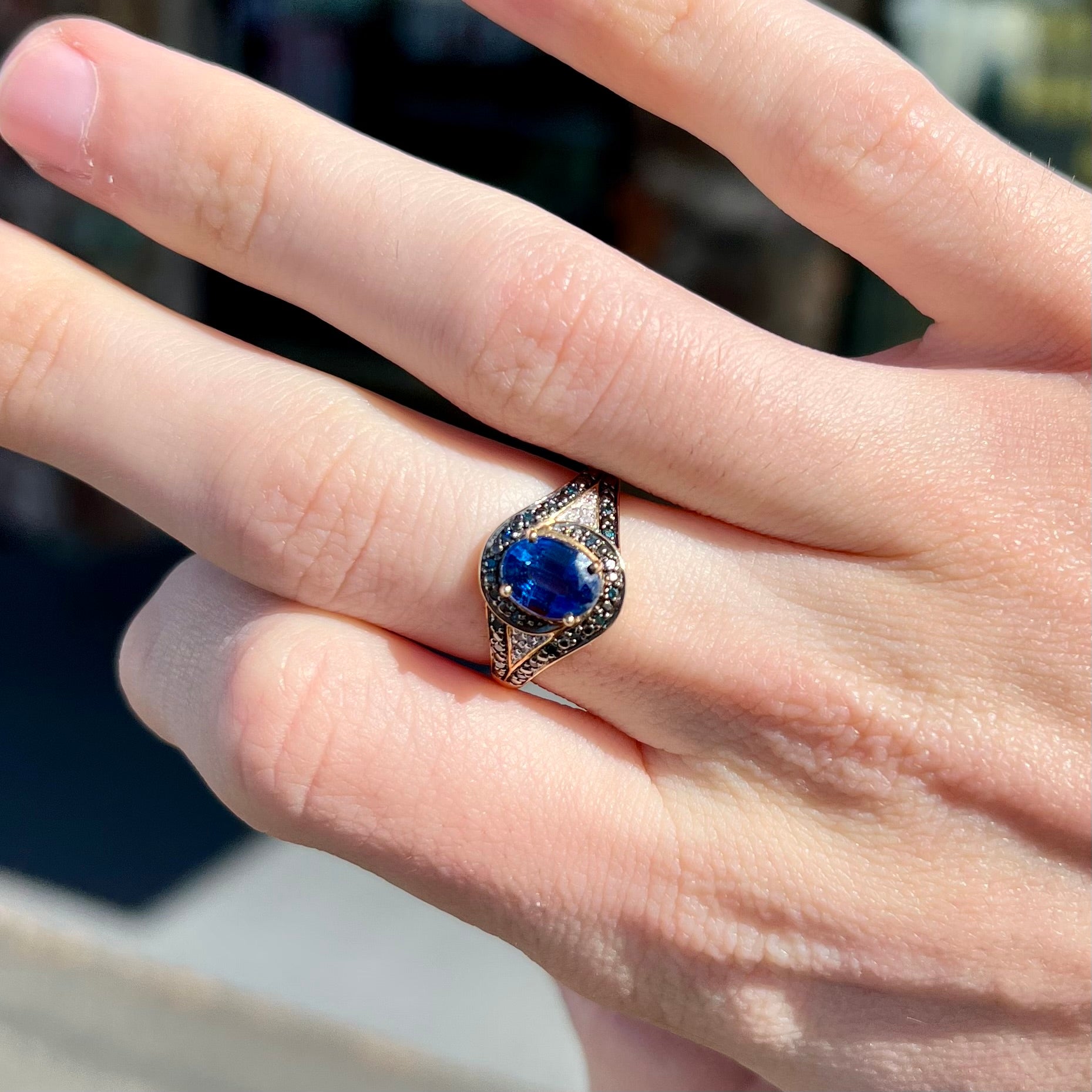 A ladies' oval cut blue kyanite twist ring pave set with blue and white diamond accents.