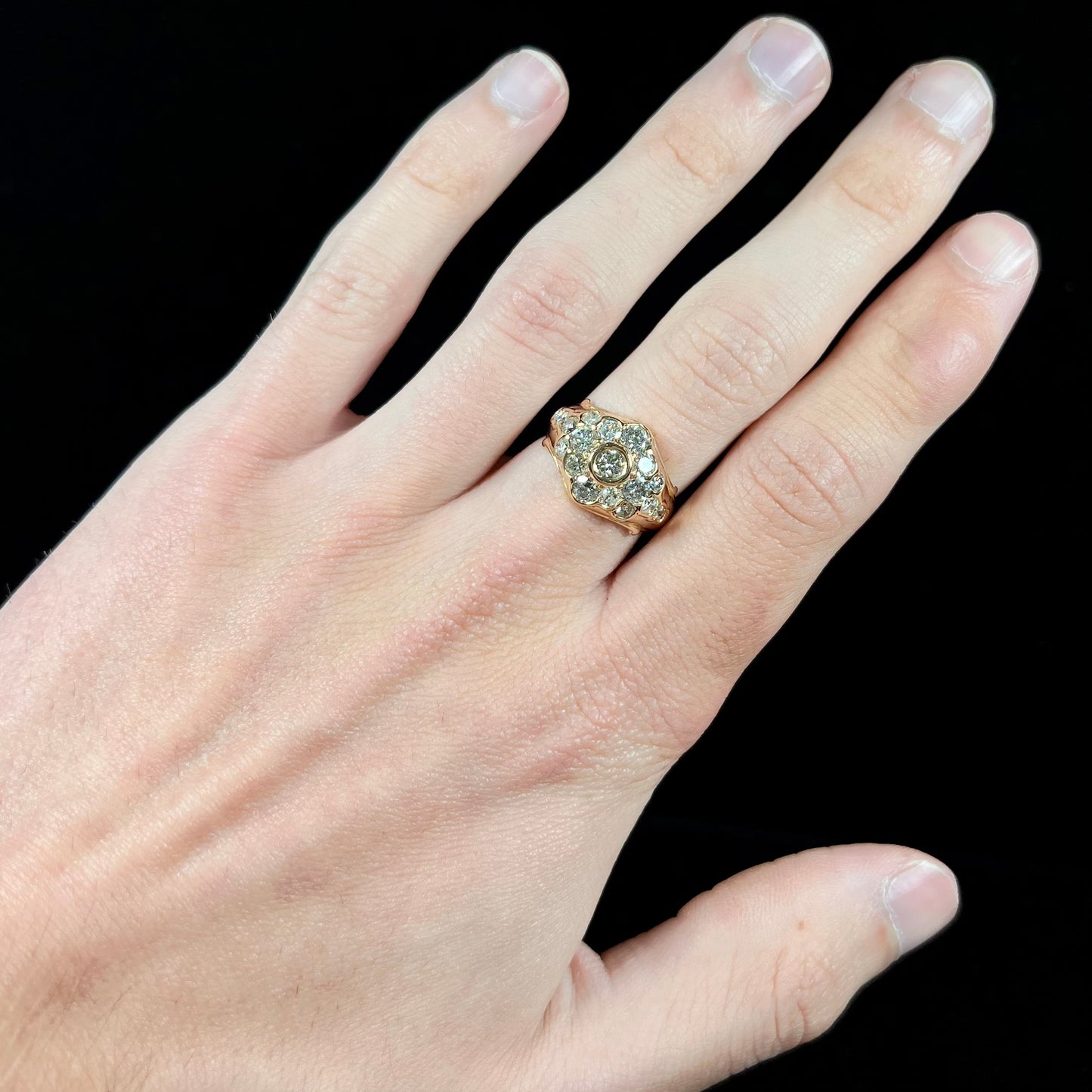 A yellow gold domed diamond ring set with 19 Standard Round Brilliant Cut diamonds.
