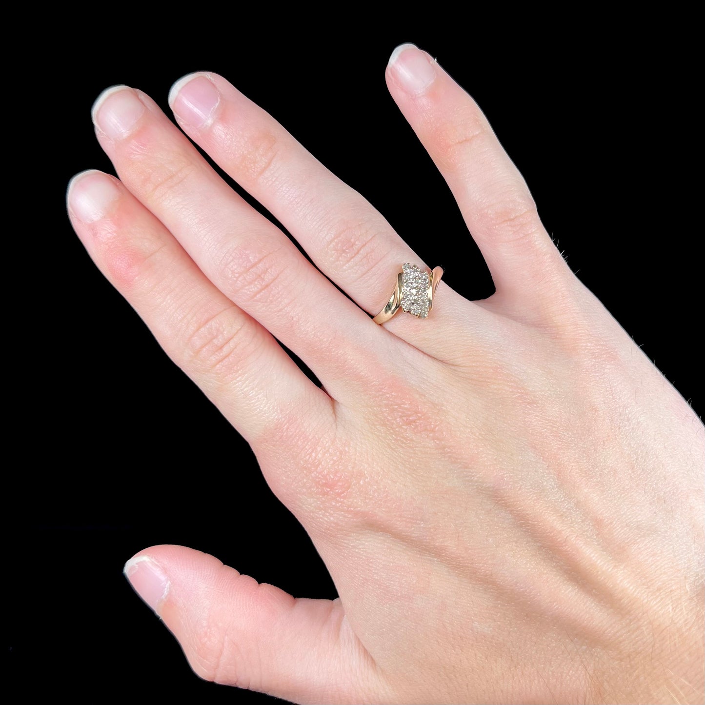 A ladies' estate yellow gold diamond cluster ring. The diamonds are round single cuts.