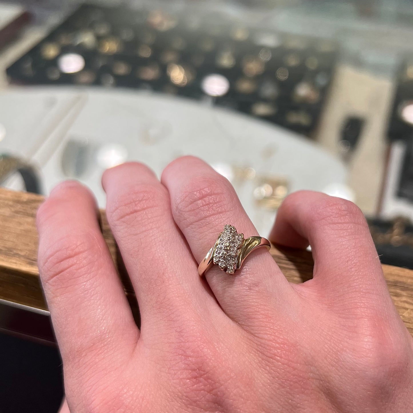 A ladies' estate yellow gold diamond cluster ring. The diamonds are round single cuts.
