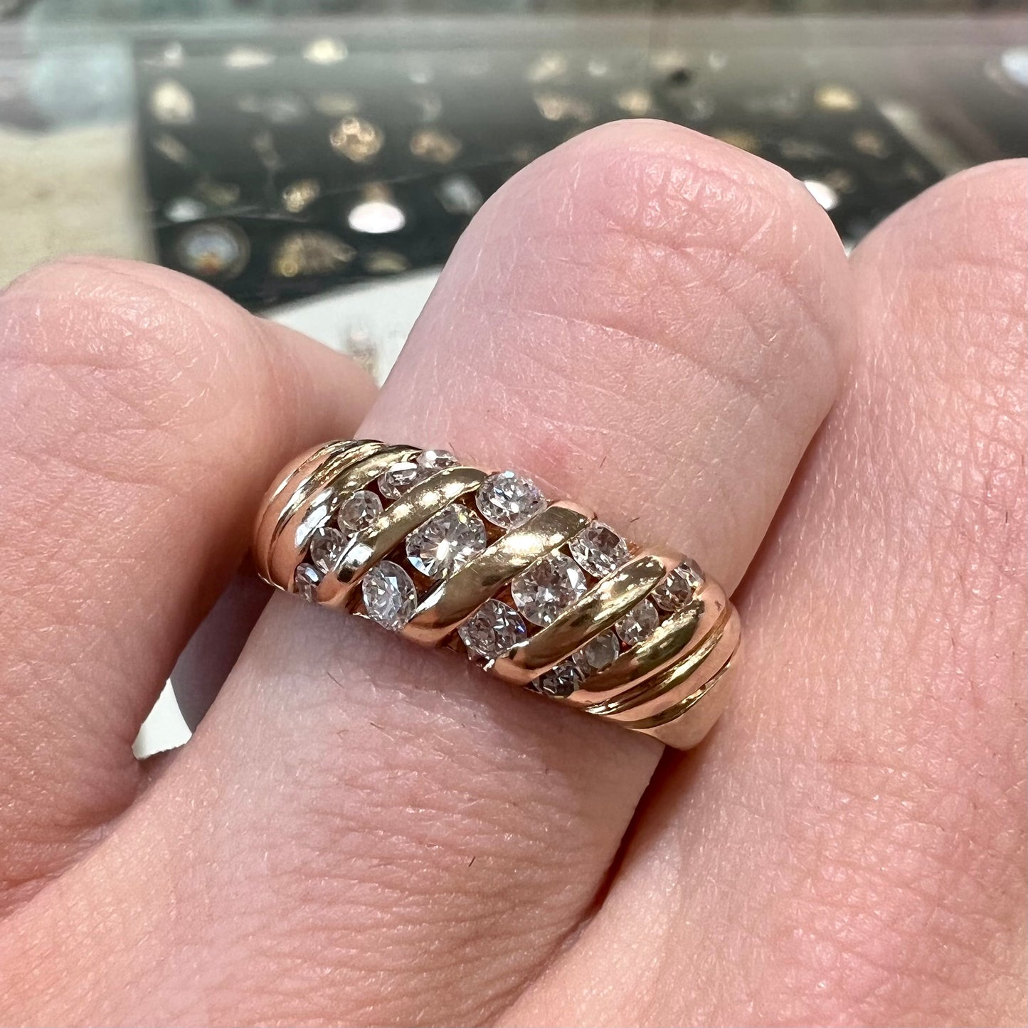 A ladies' channel set gold diamond ring.