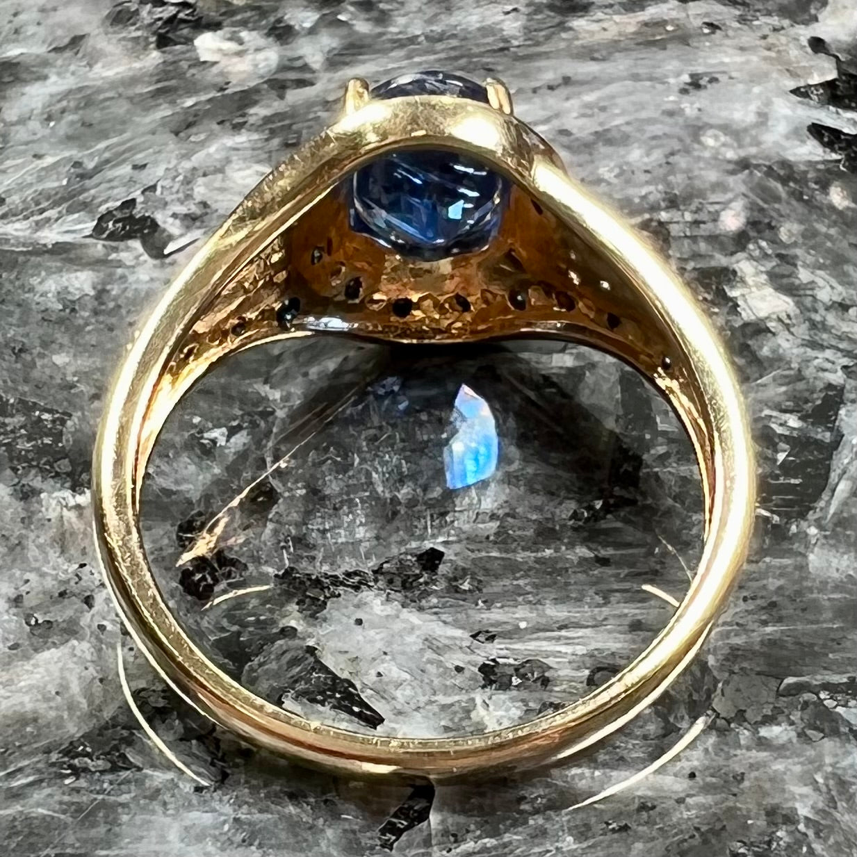 A ladies' oval cut blue kyanite twist ring pave set with blue and white diamond accents.