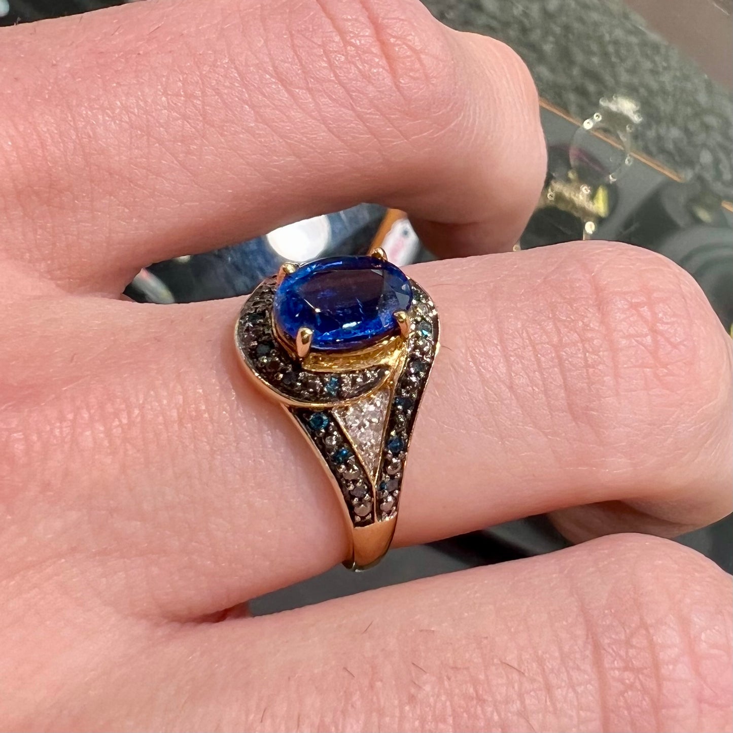 A ladies' oval cut blue kyanite twist ring pave set with blue and white diamond accents.
