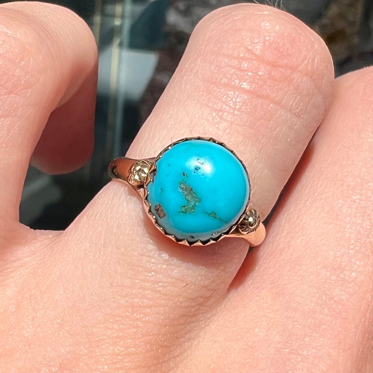 A ladies' yellow gold turquoise ring. The turquoise is a round cabochon cut.