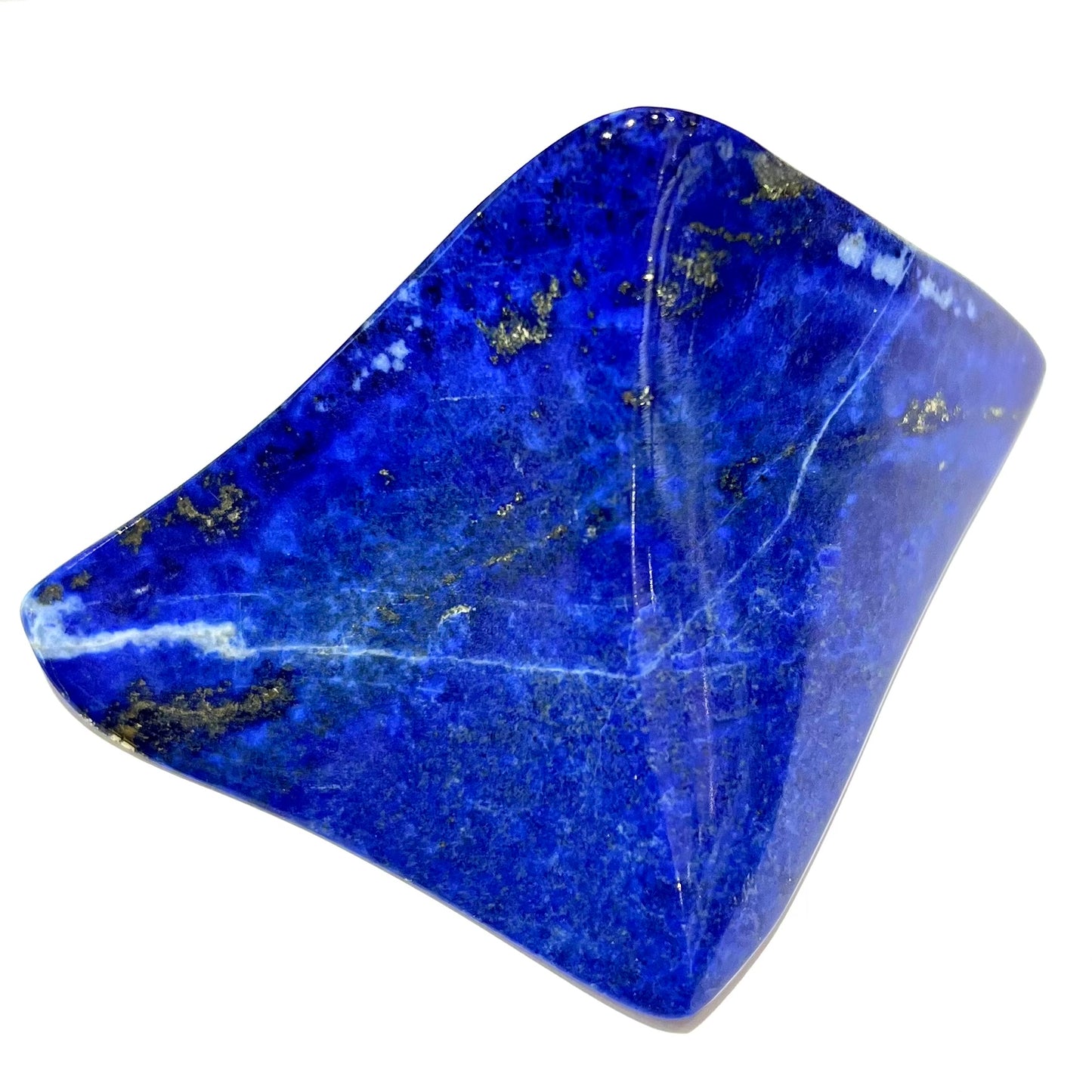A loose polished sculpture made from royal blue lapis lazuli with golden pyrite inclusions.