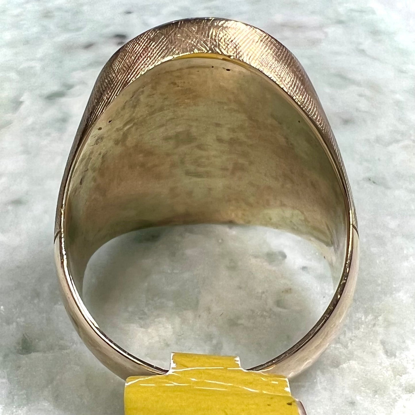 A Lightning Ridge black opal men's ring in solid yellow textured gold.